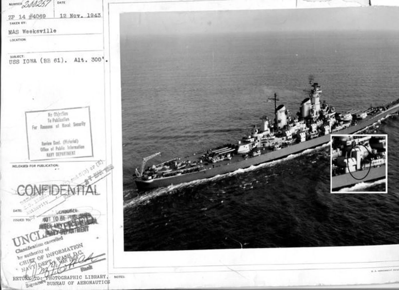 A black-and-white aerial photo of the battleship Iowa at sea appears alongside a declassified military document marked CONFIDENTIAL and dated 12 Nov. 1943. An inset highlights a section of the ship, possibly referencing the special elevator installed for FDR’s use during his historic voyage.