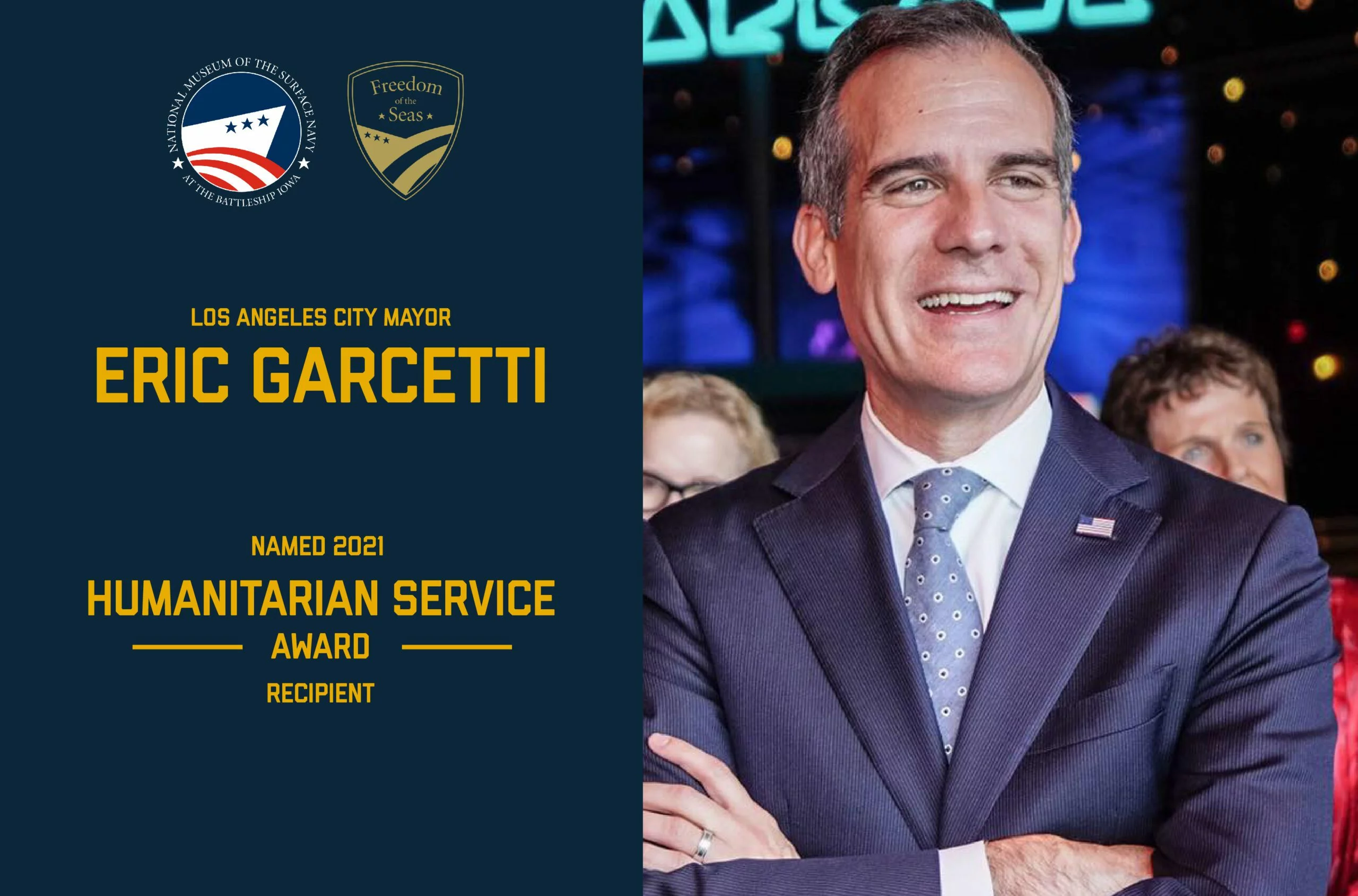 Los Angeles City Mayor Eric Garcetti smiles in a suit. Text announces he received the 2021 Humanitarian Service Award, one of the distinguished Freedom of the Seas awards. Logos for Freedom of the Seas and the City of Los Angeles appear above the text.