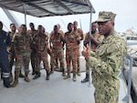 230130-N-NO901-1002 (Jan. 30, 2023) LAGOS, Nigeria - Hospital Corpsman 1st Class Agossou Marcellin, a Benin native, Pharmaceutical doctorate student, and U.S. Navy Reservist, speaks to Benin Navy Sailors during a debrief on Illegal, Unregulated and Unreported fishing in Benin, during exercise Obangame Express 2023. Obangame Express 2023, conducted by U.S. Naval Forces Africa, is a maritime exercise designed to improve cooperation, and increase maritime safety and security among participating nations in the Gulf of Guinea and Southern Atlantic Ocean. U.S. Sixth Fleet, headquartered in Naples, Italy, conducts the full spectrum of joint and naval operations, often in concert with allied and interagency partners, in order to advance U.S. national interests and security and stability in Europe and Africa. (Courtesy Photo)