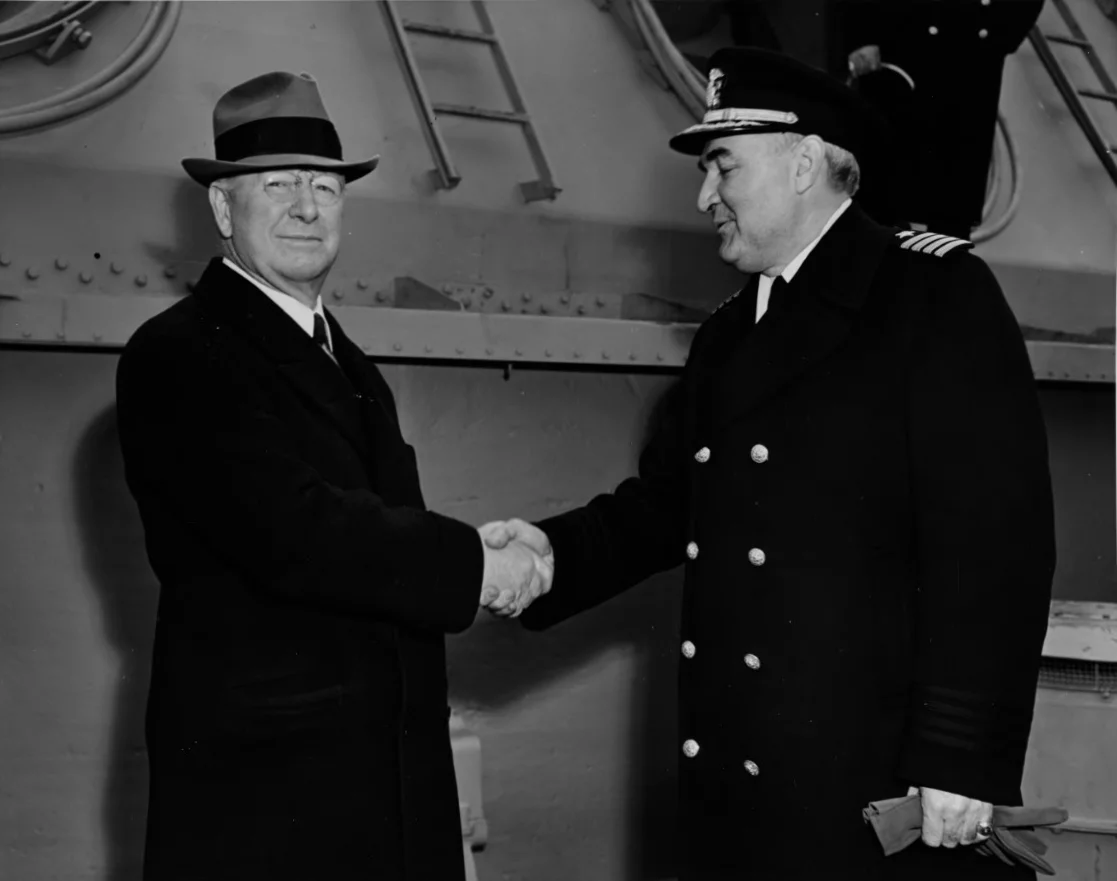NH-70496-Iowa-commissioning-2-22-43-SECNAV-Frank-Knox-congratulates-Iowa-CO-Capt-John-L-McCrea-after-ceremonies-a