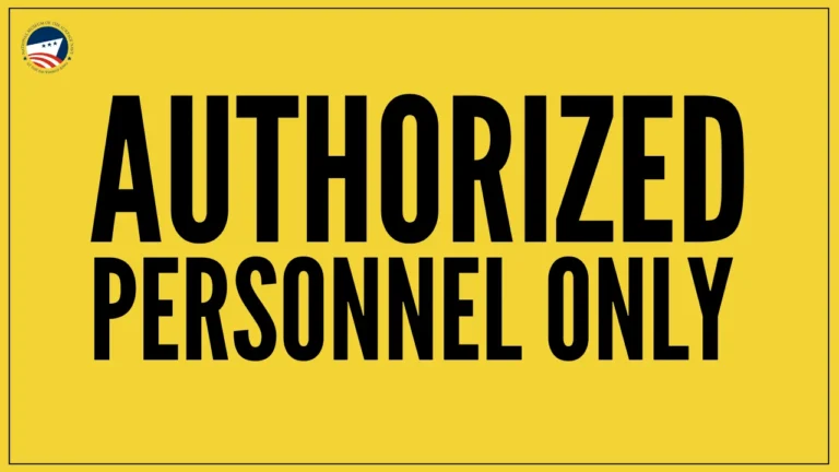 Yellow sign with bold black text reading Authorized Personnel Only. A small circular emblem with stars and stripes is in the corner.