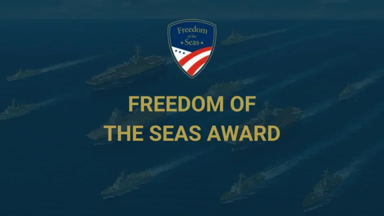 Naval ships at sea with a Freedom of the Seas Award badge above the yellow text FREEDOM OF THE SEAS AWARD centered on the image.