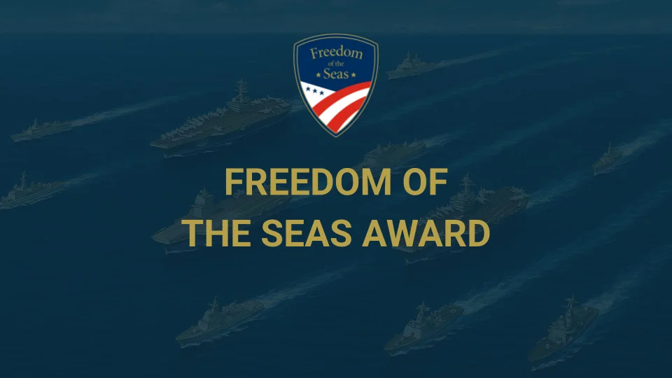 Naval ships at sea with a Freedom of the Seas Award badge above the yellow text FREEDOM OF THE SEAS AWARD centered on the image. Naval ships at sea with a Freedom of the Seas Award badge above the yellow text FREEDOM OF THE SEAS AWARD centered on the image.